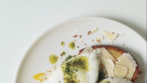 Poached Eggs and Parmesan Cheese Over Toasted Brioche with Pistou